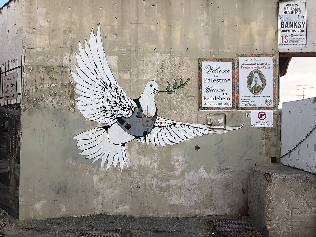 Drawing on a wall: a dove wearing a bulletproof vest